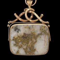 Rectangular pendant featuring white gold-bearing quartz in a gold setting, complimented by a delicate branch-like motif at the top.