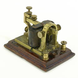 Brass telegraph sounder  on a wooden base.