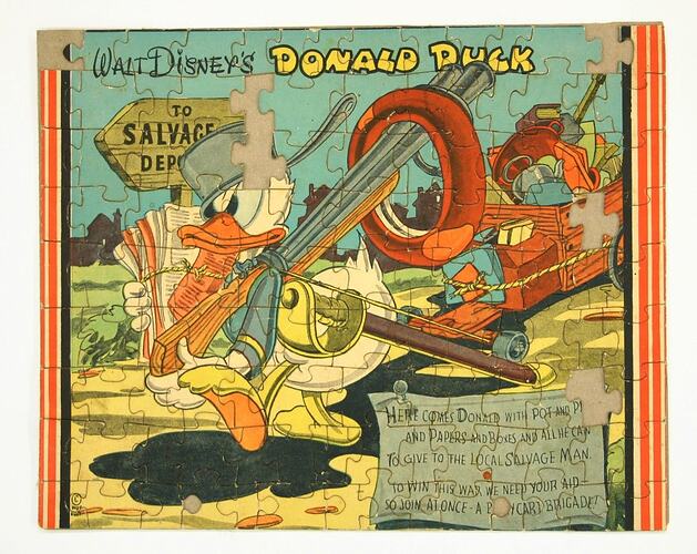 Jigsaw with cartoon Donald Duck carrying guns, a tyre, and a bundle of old newspapers.