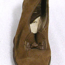 Lady's brown suede slip-on shoe.