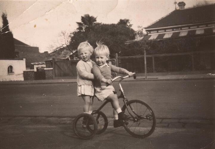 Digital Photograph - Twin Boy & Girl Riding Tricycle outside Home, Windsor, circa 1949