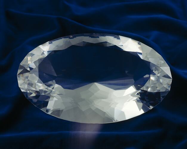 Large oval, faceted, clear gem.