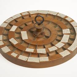 Circular wooden tray with 44 compartments.