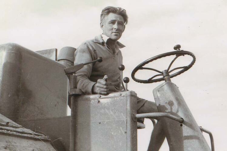 A man at the wheel of a harvester.