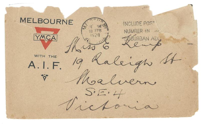 Ripped envelope with printed and handwritten text, two stamps at top.