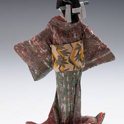 Back view of robed doll on mount.