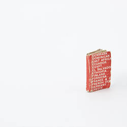 Small book with a red cover, white printing.