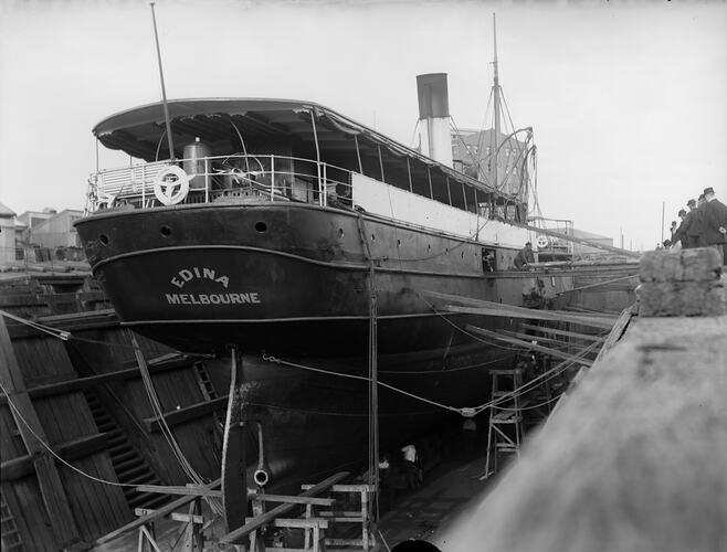 View of the stern of a single-screw steamer dry docked for repairs.