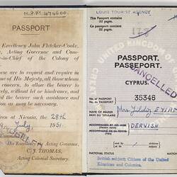 Open passport with white pages, black printing and handwriting. Stamped.