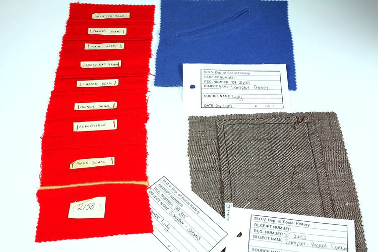 Pieces of red, blue and brown fabric, with labels.