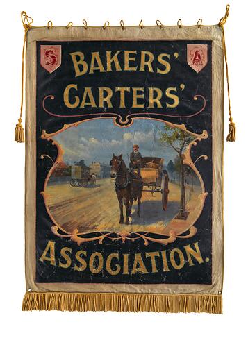 Bakers horse and carts in street scene. Text above and below. Fringed lower edge.