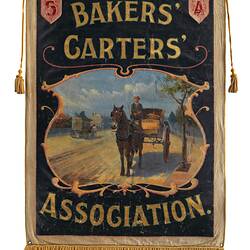 Bakers horse and carts in street scene. Text above and below. Fringed lower edge.