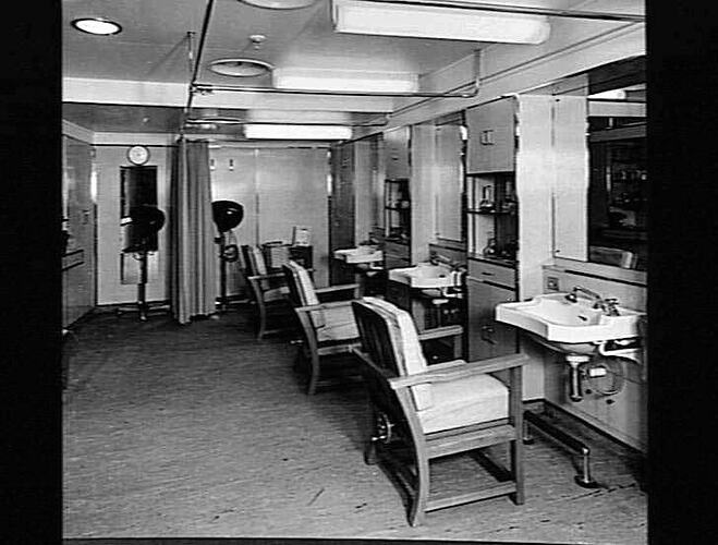 Ship interior. Hairdresser salon with three chairs and mirrors.