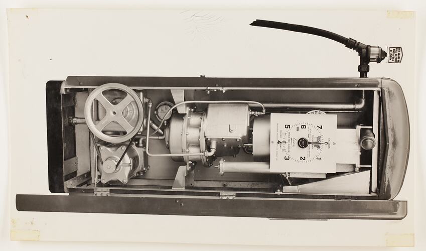 Monochrome photograph of an electric petrol pump.