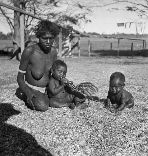 Unidentified woman and two infants with an emu chick, Milingimbi, Northern Territory,  late 1920s-30s