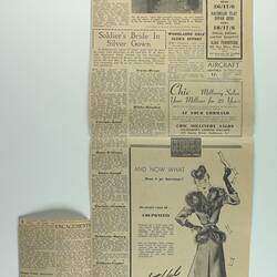 Newspaper cutting, yellowed and creased, with advertisements