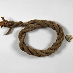 Coiled rope with one end frayed.