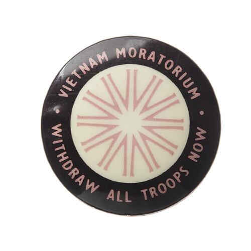 Round white badge with thick black border. Star shaped pattern. White text around edge.