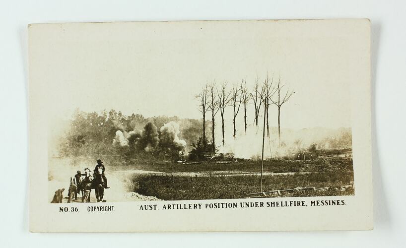 Two soldiers in a wagon pulled by two horses on a dirt road, with smoke clouds in the background.