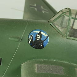 Detail of model aeroplane cockpit. Dark green. Grim reaper image on side.