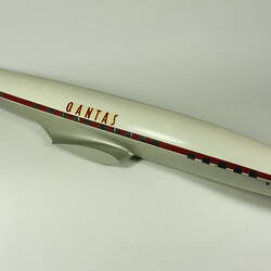 Aeroplane model painted white, red, silver and black with red text. Has windows but no wings or tail.