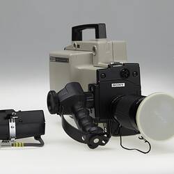 Camera with handle and black accessories.