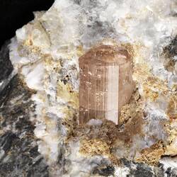 Pink crystal on white rock.