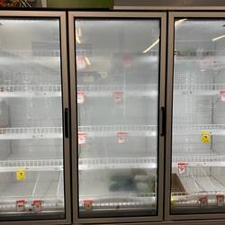 Empty supermarket freezer with glass doors.