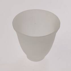 Opaque glass bell-shaped cup. Narrower at base.