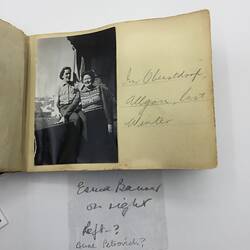 Black and white photo stuck in album with handwritten annotation in pencil along right.