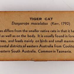 Brown rectangular label with black text.