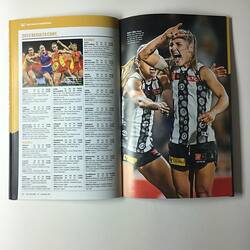 Open football record with text and female footballers on left page. Female footballers on right page.