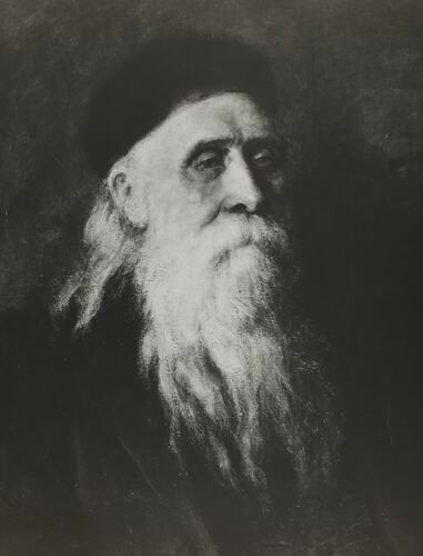 Portrait of man with long white beard.