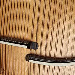 Detail of section of timber stringed instrument. Pale wood with black laquered timber detail. Multi stringed.