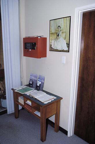 Entrance lobby with table, visitor's book, and Queen's portrait. Melbourne Coastal Radio Station, Cape Schanck, Victoria