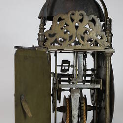 Rectangular metal clock with domed top, side view, door open.
