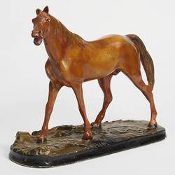 Plaster moulded, hand painted brown horse with a black base. Three quarter view.