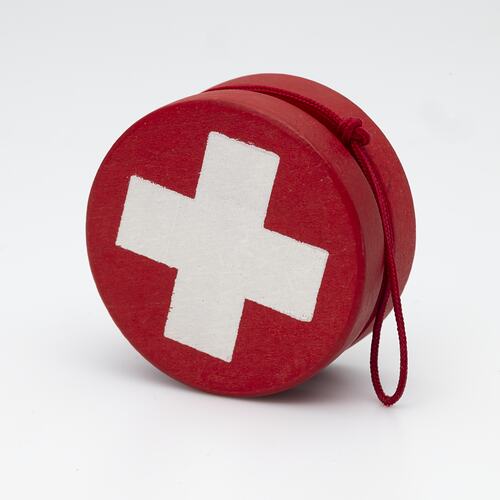 Red yo-yo with white cross.