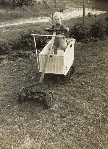 Digital Photograph - Baby trying to Mow Lawn from Pram, Springvale, 1950