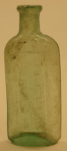 Empty green triangular bottle.