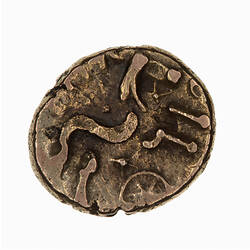Coin, irregular, crude horse to right; below, wheel; above base of letters 'COMVX'.