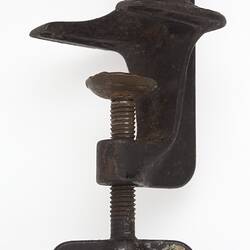 Detail of clamp on metal and wood coffee grinder.