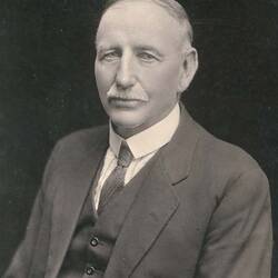 Head and shoulders portrait of man in suit.
