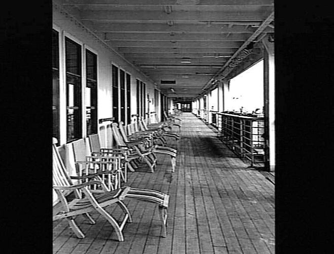 Ship promenade deck. Deck chairs at left.