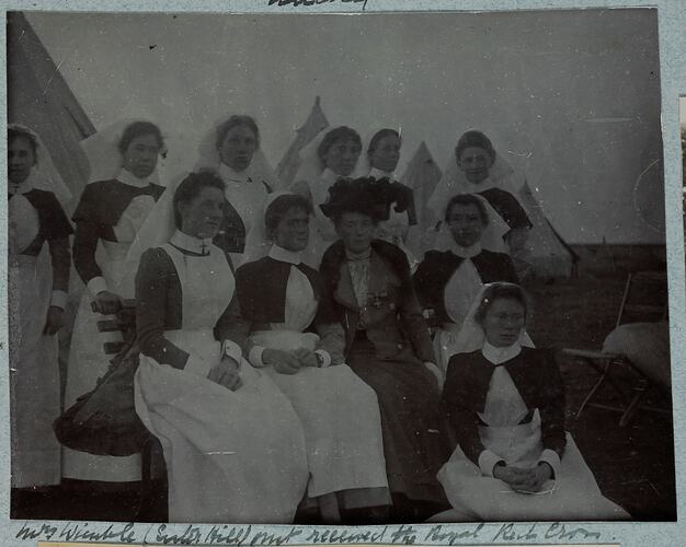 Group portrait of eleven women with ten in nurses uniform.