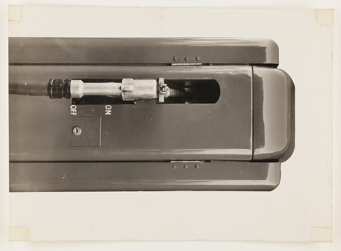 Monochrome photograph of an electric petrol pump.