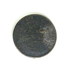 Front of circular badge with inscriptions.