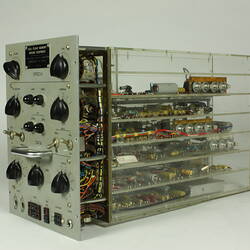 Control panel with knobs and dials. In clear box that shows internal wiring and components.