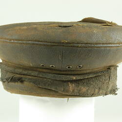 Rear view of old battered nightsoil collector's khaki flat top cap