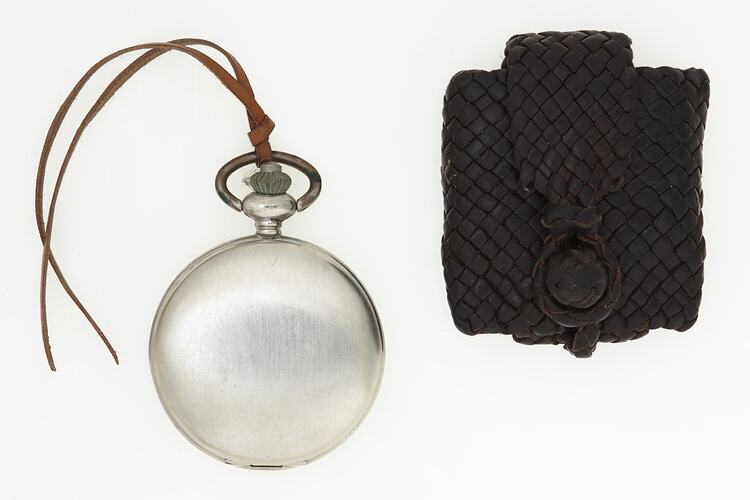 Metal fob watch with braided leather braided pouch.